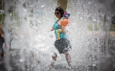Israelis play in a water fountain on an unseasonably hot summer day near the Tower of David in the Old City of Jerusalem on May 27, 2015. (Yonatan Sindel/Flash90) Israelis play in a water fountain on an unseasonably hot summer day near the Tower of David in the Old City of Jerusalem on May 27, 2015. (Yonatan Sindel/Flash90)