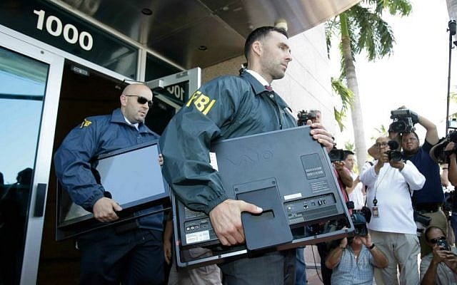 Federal agents load a van with boxes and computers taken from the headquarters of the Confederation of North, Central America and Caribbean Association Football (CONCACAF,) Wednesday, May 27, 2015, in Miami Beach, Florida. (AP Photo/Wilfredo Lee)