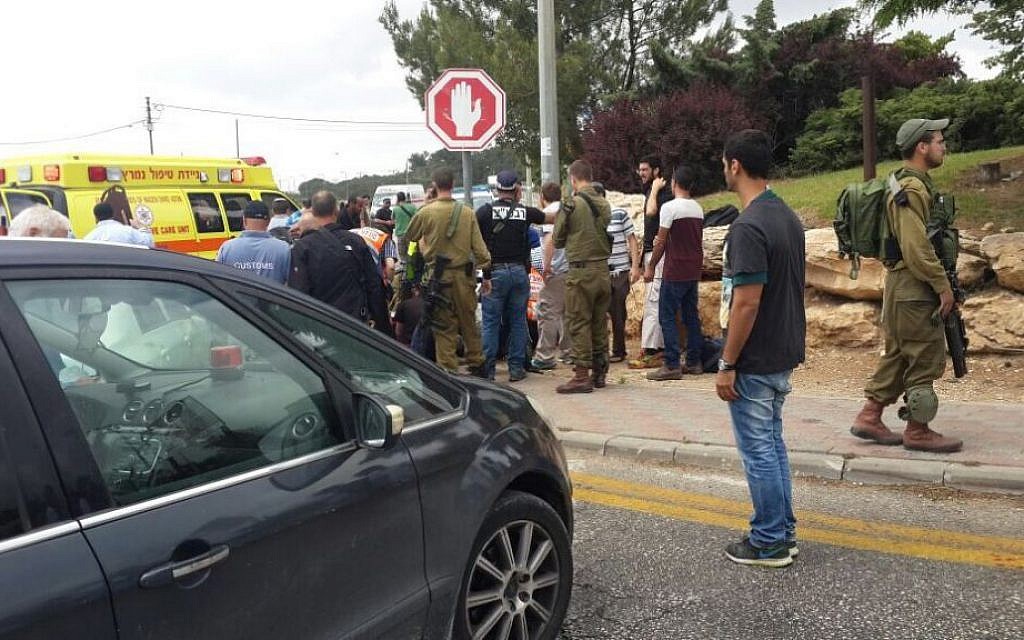 Paramedics attend to three teenagers who were hurt in a suspected car-ramming attack in Alon Shvut in the West Bank, May 14, 2015. Courtesy Zaka