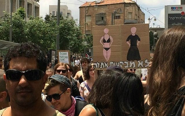 Protesters holds sign saying, 'She isn't asking for it,' at Jerusalem SlutWalk, May 29, 2015. (Renee Ghert-Zand/Times of Israel) Protesters holds sign saying, 'She isn't asking for it,' at Jerusalem SlutWalk, May 29, 2015. (Renee Ghert-Zand/Times of Israel)
