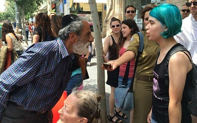 Man confronts protester at Jerusalem SlutWalk, May 29, 2015. (Renee Ghert-Zand/Times of Israel)