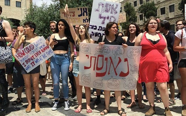 Woman holds sign saying, "I was raped" at Jerusalem SlutWalk, May 29, 2015. (Renee Ghert-Zand/Times of Israel) Woman holds sign saying, "I was raped" at Jerusalem SlutWalk, May 29, 2015. (Renee Ghert-Zand/Times of Israel)