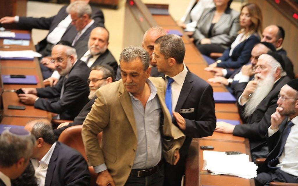 MK Jamal Zahalka is removed from the Knesset plenum after making repeated catcalls during a speech by Prime Minister Benjamin Netanyahu on Thursday, May 14, 2015 (Knesset spokesperson) MK Jamal Zahalka is removed from the Knesset plenum after making repeated catcalls during a speech by Prime Minister Benjamin Netanyahu on Thursday, May 14, 2015 (Knesset spokesperson)