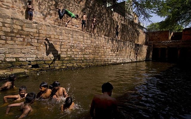 A young boy dives into a water tank on a hot summer day in New Delhi, India, Wednesday, May 27, 2015. (AP Photo/Saurabh Das) A young boy dives into a water tank on a hot summer day in New Delhi, India, Wednesday, May 27, 2015. (AP Photo/Saurabh Das)