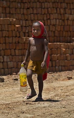 A young boy, son of a laborer, walks to a water pump to fill his bottle with drinking water on a hot summer day in Ghasera, on the outskirts of New Delhi, India, Wednesday, May 27, 2015. (AP Photo/Saurabh Das) A young boy, son of a laborer, walks to a water pump to fill his bottle with drinking water on a hot summer day in Ghasera, on the outskirts of New Delhi, India, Wednesday, May 27, 2015. (AP Photo/Saurabh Das)