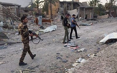 In this April 23, 2015 file photo, Iraqi security forces and tribal fighters regain control of the northern neighborhoods, after overnight heavy clashes with Islamic State group militants, in Ramadi, 70 miles (115 kilometers) west of Baghdad, Iraq. (AP Photo, File)
