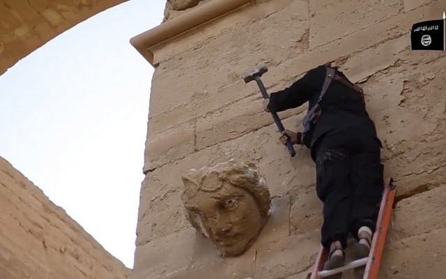In this image made from a video posted on YouTube on April 3, 2015, a militant hammers away at a face on a wall in Hatra, a large fortified Iraqi city recognized as a UNESCO World Heritage Site. (AP, File) In this image made from a video posted on YouTube on April 3, 2015, a militant hammers away at a face on a wall in Hatra, a large fortified Iraqi city recognized as a UNESCO World Heritage Site. (AP, File)