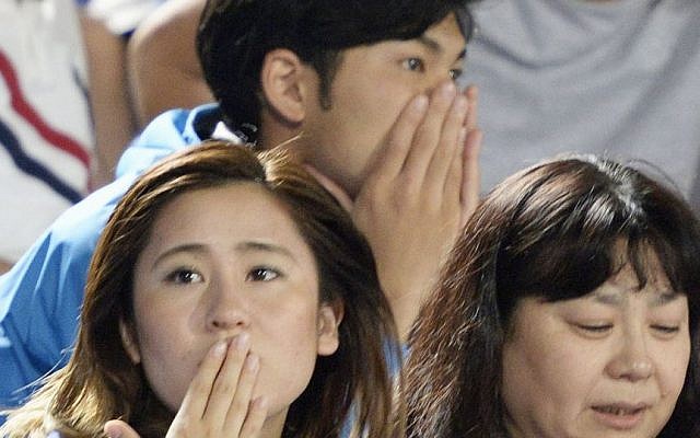 Japanese soccer fans react to a strong earthquake as they watch a J-League soccer match at BMW Stadium in Hiratsuka, southwest of Tokyo Saturday, May 30, 2015. (Munehide Someya/Kyodo News via AP) Japanese soccer fans react to a strong earthquake as they watch a J-League soccer match at BMW Stadium in Hiratsuka, southwest of Tokyo Saturday, May 30, 2015. (Munehide Someya/Kyodo News via AP)