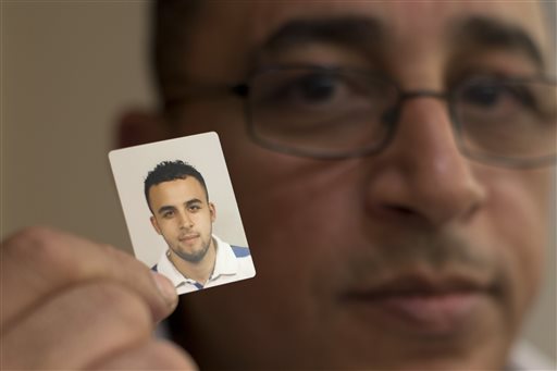 Mohamed Nidalha poses with a passport photo of his son Reda during an interview on Friday, May 15, 2015, in Leiden, Netherlands. The 20-year-old Reda, who grew up liking girls and going to discos, suddenly changed, thanks to a toxic cocktail of online propaganda and covert contact with extremists in Belgium, one of Europe’s hotspots for Islamic radicals, and eventually traveled to Syria. (AP Photo/Peter Dejong) Mohamed Nidalha poses with a passport photo of his son Reda during an interview on Friday, May 15, 2015, in Leiden, Netherlands. The 20-year-old Reda, who grew up liking girls and going to discos, suddenly changed, thanks to a toxic cocktail of online propaganda and covert contact with extremists in Belgium, one of Europe’s hotspots for Islamic radicals, and eventually traveled to Syria. (AP Photo/Peter Dejong)