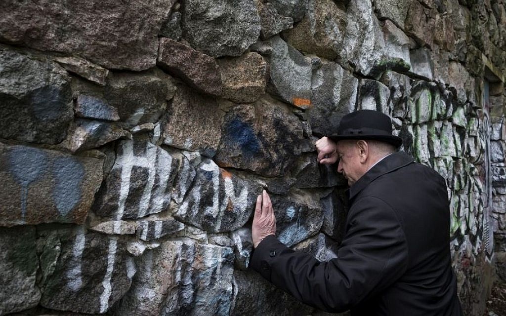 Shmuel Levin, chairperson of the Jewish religious community of Vilnius and Lithuania, leans against a wall of the power substation built of tombstones from a Jewish cemetery in Vilnius, Lithuania, May 13, 2015 (AP/Mindaugas Kulbis) Shmuel Levin, chairperson of the Jewish religious community of Vilnius and Lithuania, leans against a wall of the power substation built of tombstones from a Jewish cemetery in Vilnius, Lithuania, May 13, 2015 (AP/Mindaugas Kulbis)