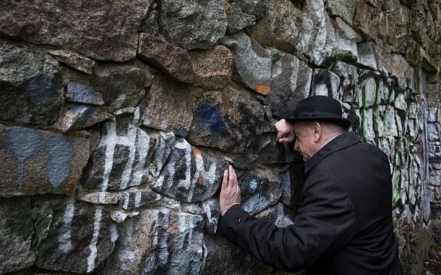 Shmuel Levin, chairperson of the Jewish religious community of Vilnius and Lithuania, leans against a wall of the power substation built of tombstones from a Jewish cemetery in Vilnius, Lithuania, May 13, 2015 (AP/Mindaugas Kulbis) Shmuel Levin, chairperson of the Jewish religious community of Vilnius and Lithuania, leans against a wall of the power substation built of tombstones from a Jewish cemetery in Vilnius, Lithuania, May 13, 2015 (AP/Mindaugas Kulbis)