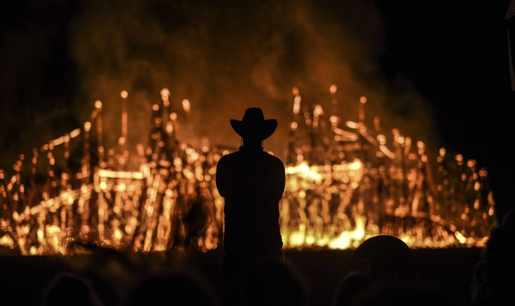 Midburn participant watches an installation burn at the second annual festival modeled after America's 'Burning Man' on May 24, 2015. (Photo credit: Ben Kelmer/Flash90) Midburn participant watches an installation burn at the second annual festival modeled after America's Burning Man on May 24, 2015. (Photo credit: Ben Kelmer/Flash90)