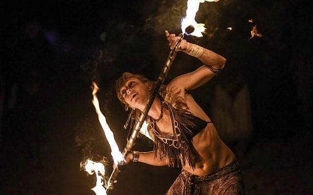 A Midburn participant twirls a flaming baton at the second annual festival modeled after America's Burning Man on May 24, 2015. (Ben Kelmer/Flash90) A Midburn participant twirls a flaming baton at the second annual festival modeled after America's Burning Man on May 24, 2015. (Ben Kelmer/Flash90)