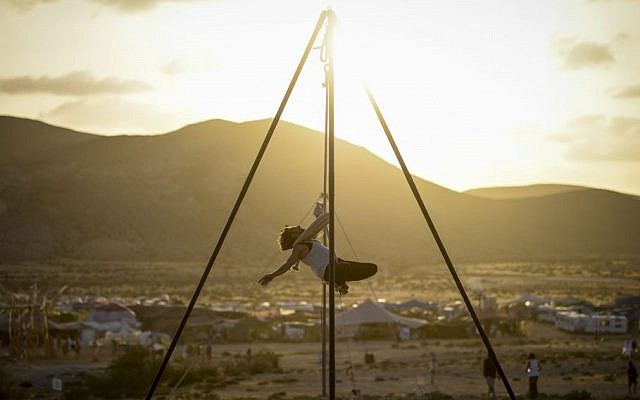 An artist performs at sunset during the second annual Midburn festival, the Israeli version of Burning Man on May 24, 2015. (Photo credit: Ben Kelmer/Flash90)