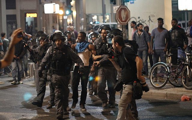Police detain an Ethiopian Israeli at an anti-police brutality demonstration in Tel Aviv's Rabin Square on Sunday, May 3, 2015. (photo credit: Judah Ari Gross/Times of Israel staff) Police detain an Ethiopian Israeli at an anti-police brutality demonstration in Tel Aviv's Rabin Square on Sunday, May 3, 2015. (photo credit: Judah Ari Gross/Times of Israel staff)