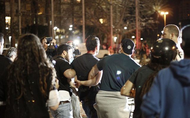 Police arrest a demonstrator at a protest in Tel Aviv's Rabin Square on Sunday, May 3, 2015. (photo credit: Judah Ari Gross/Times of Israel staff) Police arrest a demonstrator at a protest in Tel Aviv's Rabin Square on Sunday, May 3, 2015. (photo credit: Judah Ari Gross/Times of Israel staff)