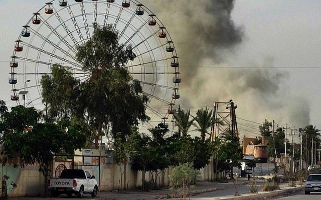 In this Saturday, May 9, 2015 file photo, a plume of smoke rises after an airstrike by the US-led coalition against Islamic State positions in an eastern neighborhood of Ramadi, the capital of Anbar province, 70 miles (115 kilometers) west of Baghdad, Iraq. (AP Photo, File)
