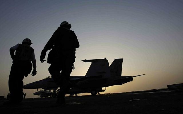 In this Aug. 10, 2014 file photo, US Navy sailors work on aircraft for missions targeting the Islamic State group in Iraq on the deck of the US Navy aircraft carrier USS George H. W. Bush in the Persian Gulf. (AP Photo/Hasan Jamali, File) In this Aug. 10, 2014 file photo, US Navy sailors work on aircraft for missions targeting the Islamic State group in Iraq on the deck of the US Navy aircraft carrier USS George H. W. Bush in the Persian Gulf. (AP Photo/Hasan Jamali, File)
