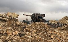 A Hezbollah cannon directed toward Syria in a military position for the group in the fields of the Lebanese border village of Brital, Lebanon, May 9, 2015. (photo credit: AP/Bassem Mroue)