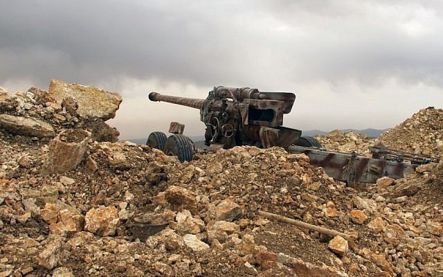 A Hezbollah cannon directed toward Syria in a military position for the group in the fields of the Lebanese border village of Brital, Lebanon, May 9, 2015. (photo credit: AP/Bassem Mroue) 