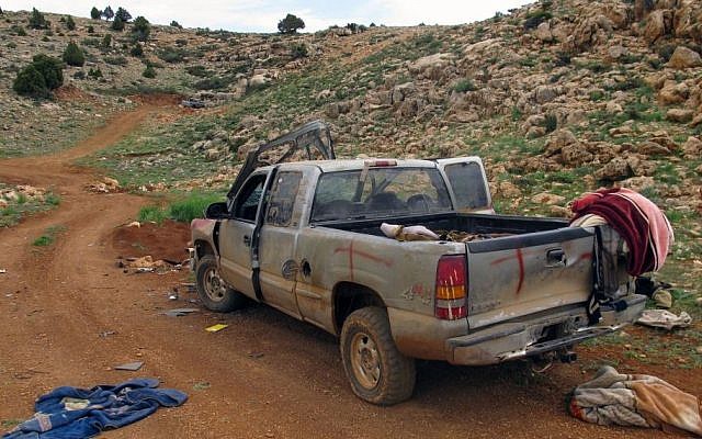 A damaged SUV left behind by members of the al-Nusra Front, al-Qaeda's branch in Syria, in a position captured by Lebanon's Hezbollah fighters in the fields of the Syrian border town of Assal al-Ward, May 9, 2015. (photo credit: AP/Bassem Mroue) 