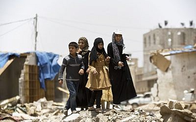 A boy and his sisters watch graffiti artists spray-paint on a wall, commemorating the victims who were killed in Saudi-led coalition airstrikes on Sana'a, Yemen, May 18, 2015. (AP/Hani Mohammed) A boy and his sisters watch graffiti artists spray-paint on a wall, commemorating the victims who were killed in Saudi-led coalition airstrikes on Sana'a, Yemen, May 18, 2015. (AP/Hani Mohammed)