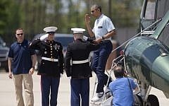 In a Sunday, May 3, 2015 file photo, President Barack Obama salutes as he steps off of Marine One, in Andrews Air Force Base, Md., as he returns from the presidential retreat at Camp David, Md. (Photo credit: AP/Carolyn Kaster, File)