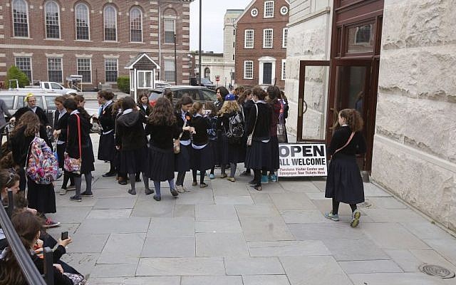 In this Thursday, May 28, 2015 photo, school girls gather outside the visitor's center at the Touro Synagogue during a tour in Newport, Rhode Island. (AP Photo/Stephan Savoia)