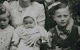 This photograph, taken in 1947 in Dzierzoniow, Poland, shows Moshe Tirosh as a boy with his mother and siblings. Then named Mieczyslaw Kenigswein, Tirosh is the boy on the right. Mother Regina is at the top left, with daughter Stefania by her side. In the front are children Stanislaw and Rachel. (Photo credit:  Warsaw Zoo via AP)