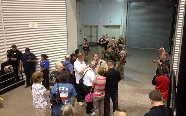 People are sequestered by members of the Garland Police Department inside the Curtis Culwell Center, Sunday, May 3, 2015, in Garland, Texas. A contest for cartoons depictions of the Prophet Muhammad in the Dallas suburb is on lockdown Sunday after authorities reported a shooting outside the building. (photo credit: AP/Nomaan Merchant) People are sequestered by members of the Garland Police Department inside the Curtis Culwell Center, Sunday, May 3, 2015, in Garland, Texas. A contest for cartoons depictions of the Prophet Muhammad in the Dallas suburb is on lockdown Sunday after authorities reported a shooting outside the building. (photo credit: AP/Nomaan Merchant)