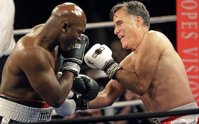 Former Republican presidential candidate Mitt Romney, right, throws punches with five-time heavyweight boxing champion Evander Holyfield at a charity fight night event Friday, May 15, 2015, in Salt Lake City (AP Photo/Rick Bowmer) Former Republican presidential candidate Mitt Romney, right, throws punches with five-time heavyweight boxing champion Evander Holyfield at a charity fight night event Friday, May 15, 2015, in Salt Lake City (AP Photo/Rick Bowmer)