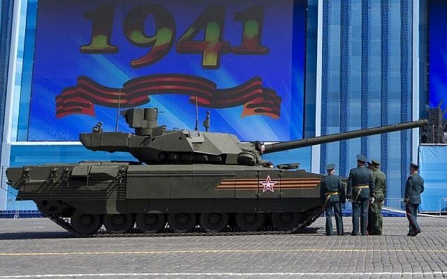 Russian army officers discuss a situation with a crew member of the new Russian T-14 Armata tank in Red Square during a rehearsal two days before the Victory Day military parade, Moscow, May 7, 2015. (photo credit: AP/Alexander Zemlianichenko) Russian army officers discuss a situation with a crew member of the new Russian T-14 Armata tank in Red Square during a rehearsal two days before the Victory Day military parade, Moscow, May 7, 2015. (photo credit: AP/Alexander Zemlianichenko)