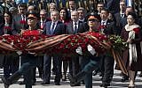 Venezuelan president's wife Cilia Flores, Venezuela's president Nicolas Maduro, Kazakh president Nursultan Nazarbayev, Russian president Vladimir Putin, Chinese president Xi Jinping and Chinese first lady Peng Liyuan attend a wreath-laying ceremony at the Tomb of the Unknown Soldier in Moscow after the Victory Parade marking the 70th anniversary of the defeat of the Nazis in World War II, in Red Square, Moscow, Russia, Saturday, May 9, 2015. At fourth left is Cuban president Raul Castro. (photo credit: AP Photo/Pavel Golovkin)