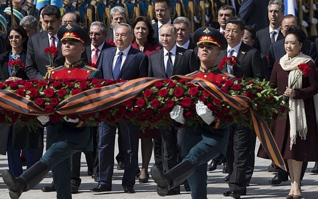 Venezuelan president's wife Cilia Flores, Venezuela's president Nicolas Maduro, Kazakh president Nursultan Nazarbayev, Russian president Vladimir Putin, Chinese president Xi Jinping and Chinese first lady Peng Liyuan attend a wreath-laying ceremony at the Tomb of the Unknown Soldier in Moscow after the Victory Parade marking the 70th anniversary of the defeat of the Nazis in World War II, in Red Square, Moscow, Russia, Saturday, May 9, 2015. At fourth left is Cuban president Raul Castro. (photo credit: AP Photo/Pavel Golovkin) Venezuelan president's wife Cilia Flores, Venezuela's president Nicolas Maduro, Kazakh president Nursultan Nazarbayev, Russian president Vladimir Putin, Chinese president Xi Jinping and Chinese first lady Peng Liyuan attend a wreath-laying ceremony at the Tomb of the Unknown Soldier in Moscow after the Victory Parade marking the 70th anniversary of the defeat of the Nazis in World War II, in Red Square, Moscow, Russia, Saturday, May 9, 2015. At fourth left is Cuban president Raul Castro. (photo credit: AP Photo/Pavel Golovkin)