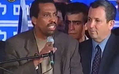 Adisu Masallah delivers a speech alongside Ehud Barak after losing his Knesset seat in 1999 (screen capture: YouTube)