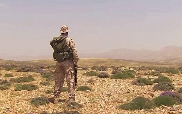 A Hezbollah fighter surveys the horizon, illustrative photo (YouTube screen capture/CNN) A Hezbollah fighter surveys the horizon, illustrative photo (YouTube screen capture/CNN)