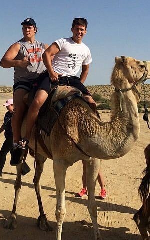 Hump day: Ali Marpet, in rear, and his longtime friend Jake Fuerst riding a camel during a Birthright Israel trip in the summer of 2014. (Courtesy of Jake Fuerst/JTA)