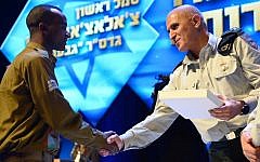 Sergeant Chalachew Mekonen receives a citation for service during Operation Protective Edge from Southern Command chief Sami Turgeman in February 2015. (IDF Spokesperson's Unit)