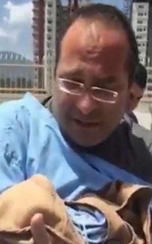 An Israeli father with a newborn child outside a hospital in Kathmandu, Nepal on May 12, 2015. (screen capture: Ynet)