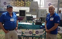 Professor Zeev Schmilovitch (L) and Eshet Eilon CEO Menashe Tamir with the company's NIR technology date sorting machine (Photo credit: Courtesy)
