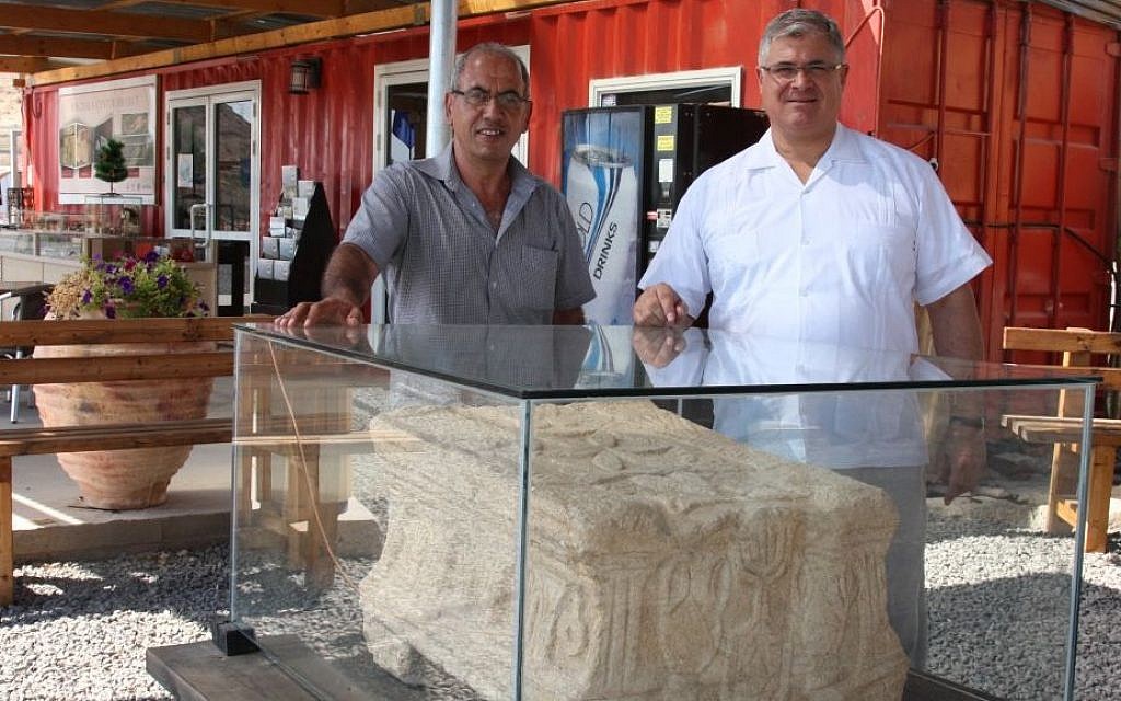 Father Juan (right) and archaeologist Arfan Najjar with the altar stone at Magdala (Shmuel Bar-Am)