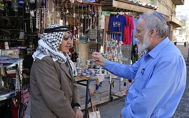 A Palestinian and a Jew seen talking outside a shop near the Cave of the Patriarchs in Hebron, on December 10, 2014. (Gershon Elinson/Flash90) A Palestinian and a Jew seen talking outside a shop near the Cave of the Patriarchs in Hebron, on December 10, 2014. (Gershon Elinson/Flash90)
