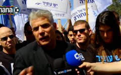 A screenshot of Yesh Atid chairman Yair Lapid during a protest against Prime Minister Benjamin Netanyahu's coalition agreements with UTJ and Shas. (screen capture: Channel 10)