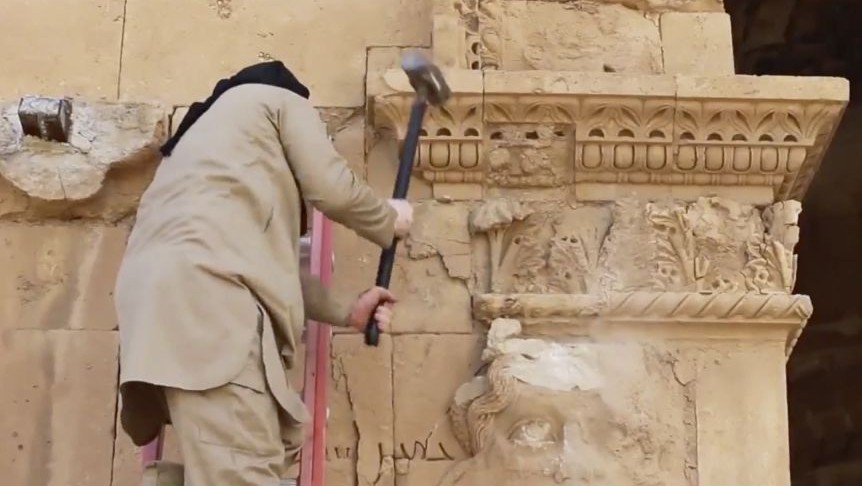 Illustrative: In this image made from a militant video posted on YouTube on Friday, April 3, 2015, a militant hammers away at a face on a wall in Hatra, a large fortified city recognized as a UNESCO World Heritage site, 110 kilometers (68 miles) southwest of Mosul, Iraq. (Photo credit: Militant video via AP) Illustrative: In this image made from a militant video posted on YouTube on Friday, April 3, 2015, a militant hammers away at a face on a wall in Hatra, a large fortified city recognized as a UNESCO World Heritage site, 110 kilometers (68 miles) southwest of Mosul, Iraq. (Photo credit: Militant video via AP)