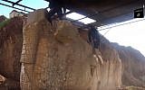 In this image made from video posted on a social media account affiliated with the Islamic State group on Thursday, Feb. 26, 2015, militants destroy winged-bull Assyrian protective deity in the Ninevah Museum in Mosul, Iraq. (Photo credit: (AP via militant social media account, File)