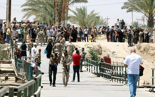 Residents from the city of Ramadi, who fled their homes on May 16, 2015 as Islamic State (IS) group militants tightened their siege on the last government positions in the capital of Anbar province, a day after they seized the city's government headquarters, wait to cross Bzeibez bridge, on the southwestern frontier of Baghdad with Anbar province, after IS group jihadists took control of all the other routes connecting the province with the Iraqi capital. Taking control of Ramadi would constitute the group's most important victory this year in Iraq, and would give the jihadists control of the capitals of two of its largest provinces. AFP PHOTO/SABAH ARAR Residents from the city of Ramadi, who fled their homes on May 16, 2015 as Islamic State (IS) group militants tightened their siege on the last government positions in the capital of Anbar province, a day after they seized the city's government headquarters, wait to cross Bzeibez bridge, on the southwestern frontier of Baghdad with Anbar province, after IS group jihadists took control of all the other routes connecting the province with the Iraqi capital. Taking control of Ramadi would constitute the group's most important victory this year in Iraq, and would give the jihadists control of the capitals of two of its largest provinces. AFP PHOTO/SABAH ARAR