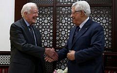 Palestinian Authority President Mahmud Abbas shakes hands with former US president Jimmy Carter during their meeting on May 2, 2015, in the West Bank city of Ramallah. (AFP/Pool/Abbas Momani)