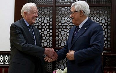 Palestinian Authority President Mahmud Abbas shakes hands with former US president Jimmy Carter during their meeting on May 2, 2015, in the West Bank city of Ramallah. (AFP/Pool/Abbas Momani)