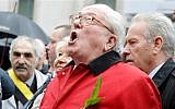 France’s far-right National Front party’s founder Jean-Marie Le Pen screams 'Help Jeanne d'Arc' after he places a wreath at Joan of Arc's statue during its annual May Day march, in Paris, France, Friday, May 1, 2015 (photo credit: AP/Francois Mori)
