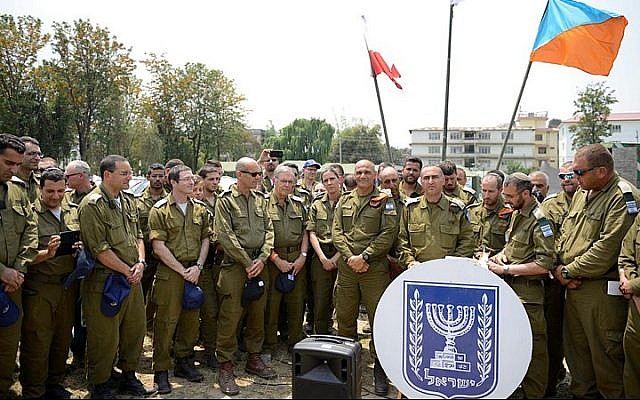 Israeli soldiers in Nepal seen as they receive a phone call from President Reuven Rivlin, on May 07, 2015. (Photo credit: IDF Spokesperson)